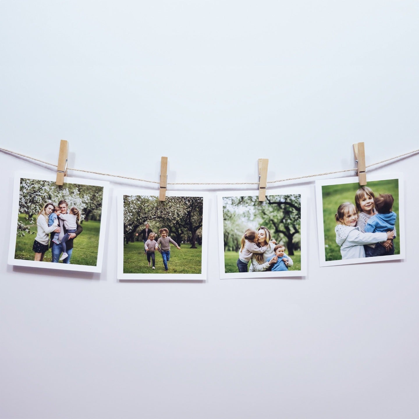 Square photo print with border hanging on string